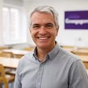 Aeneas Lowe, senior tech educator with grey hair and warm smile, standing in a bright Grangegorman classroom