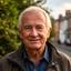 Rudolfs Cheatley, retired construction supervisor with a kind face, outdoors in natural light